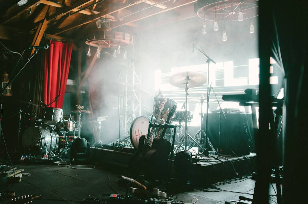 Backstage view of a concert stage with lights and equipment